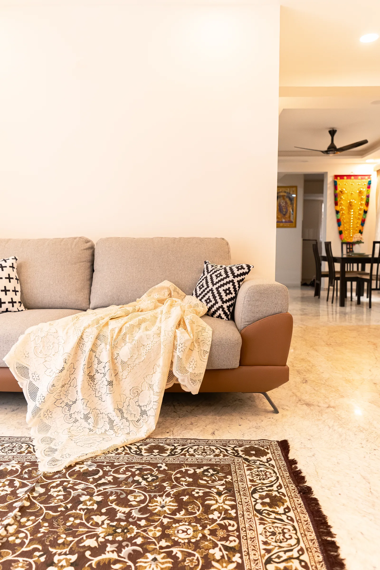 Living room with grey sofa and patterned rug — Karthik's Residence